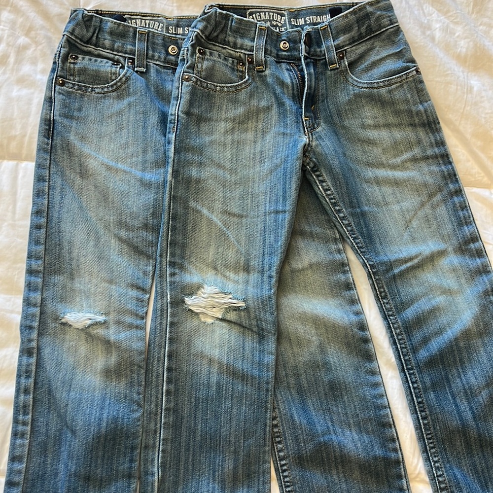 Two pairs of distressed Levi’s slim, straight jeans for boys size 7.